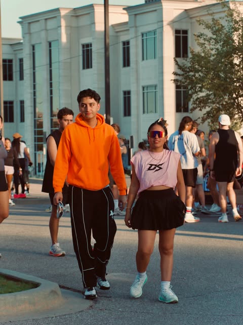 Community members walking along an Oklahoma City street in the evening
